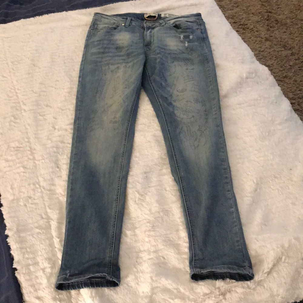 Distressed graffiti skinny jeans